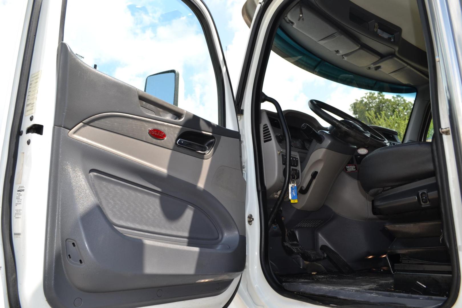 2015 WHITE /BLACK PETERBILT 567 (1XPCD49X3FD) with an CUMMINS X15 14.9L 450 HP engine, 10 SPD MANUAL transmission, located at 9172 North Fwy, Houston, TX, 77037, (713) 910-6868, 29.887470, -95.411903 - FRONT AXLE: 14,320 LB / REAR AXLE: 40,000 LB / STEERABLE LIFT AXLE: 13,000 LB, 17 FT DUMP BED, 17 CUBIC YARDS, AIR TRAC SUSPENSION, DIFF LOCK, ENGINE BRAKE, WHEELBASE: 225", RATIO: 3.70, ELECTRIC TARP, POWER WINDOWS & LOCKS , DUAL STACKS - Photo#11