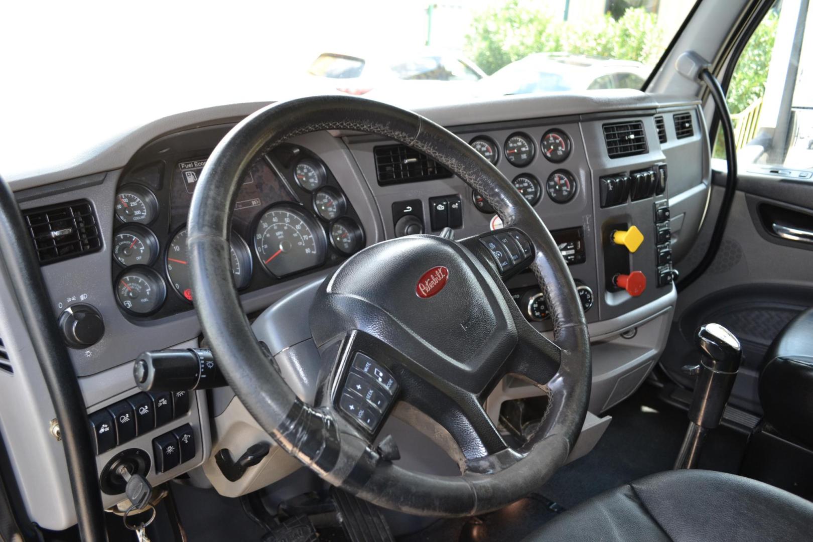 2015 WHITE /BLACK PETERBILT 567 (1XPCD49X3FD) with an CUMMINS X15 14.9L 450 HP engine, 10 SPD MANUAL transmission, located at 9172 North Fwy, Houston, TX, 77037, (713) 910-6868, 29.887470, -95.411903 - FRONT AXLE: 14,320 LB / REAR AXLE: 40,000 LB / STEERABLE LIFT AXLE: 13,000 LB, 17 FT DUMP BED, 17 CUBIC YARDS, AIR TRAC SUSPENSION, DIFF LOCK, ENGINE BRAKE, WHEELBASE: 225", RATIO: 3.70, ELECTRIC TARP, POWER WINDOWS & LOCKS , DUAL STACKS - Photo#13